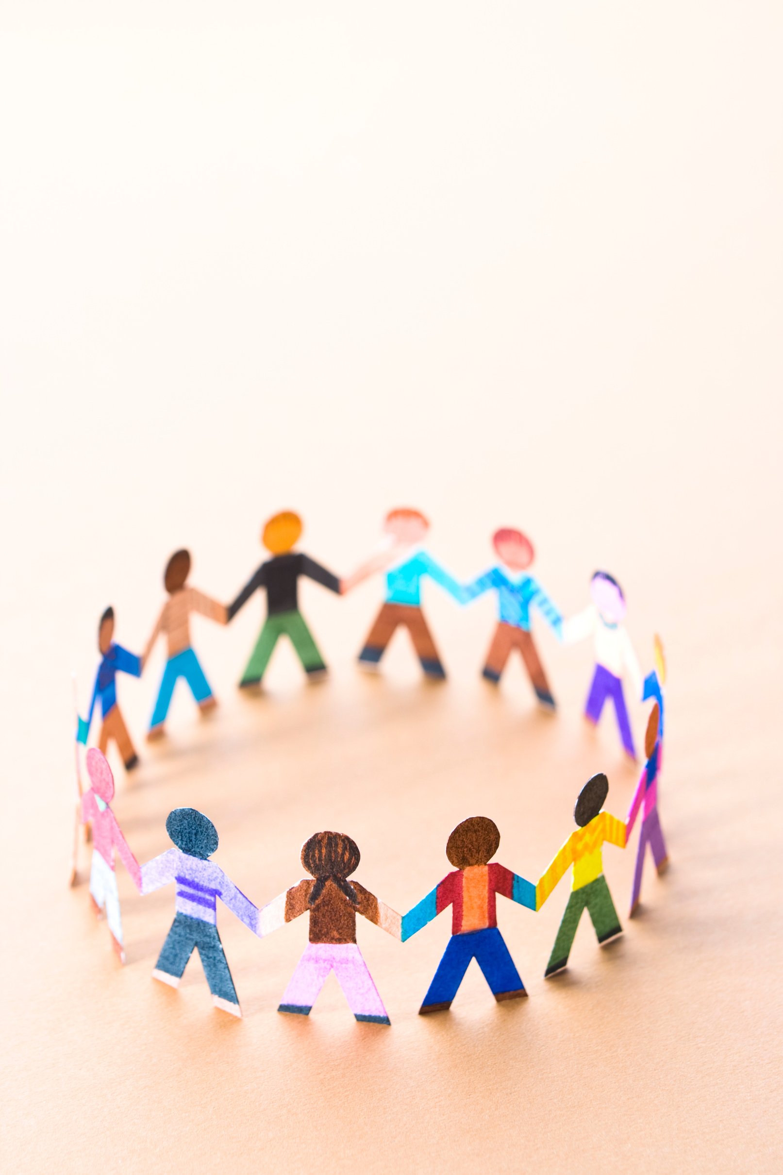 Circle of diverse children figurines holding hands